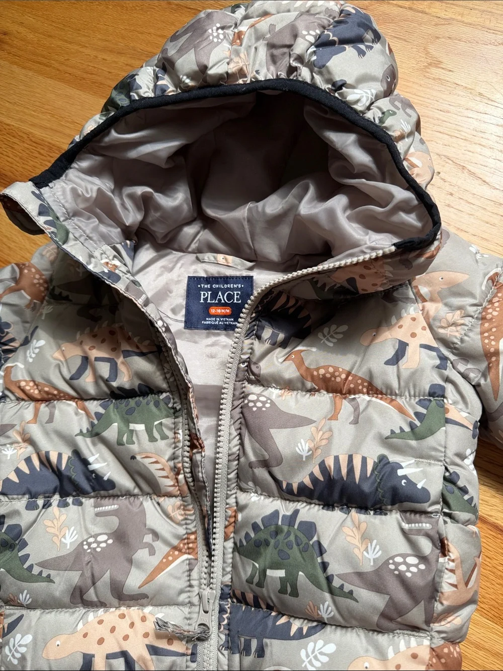 The Children's Place Dino Hooded Puffer Jacket in Tan, Green & Navy